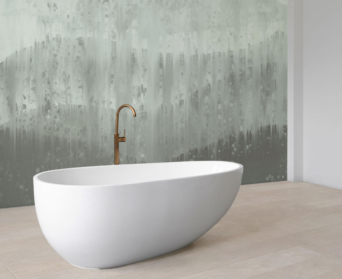 A modern white freestanding bathtub with a gold faucet sits on light wood flooring in front of a gray and white abstract wall.