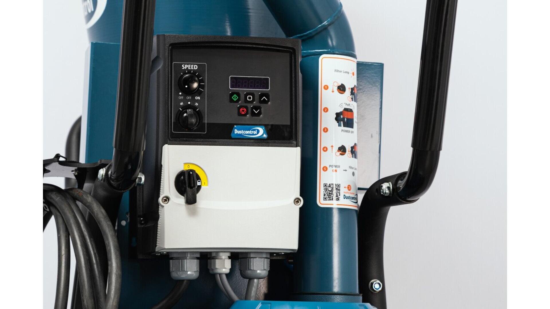 Close-up view of a machine control panel featuring a digital display, speed control dial, buttons, switches, and labeled wiring. Black handles and cables are visible on both sides of the blue and white equipment.